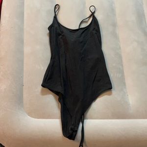 A black body suit with a open back